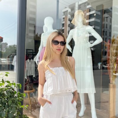 Beyaz, Detaylı Askılı Crop ve beyaz pantolon giyen sarı saçlı kadın.